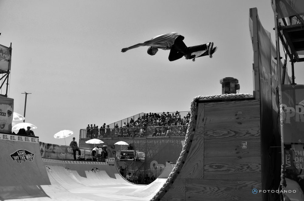Skater flying over the ramp, in black and white