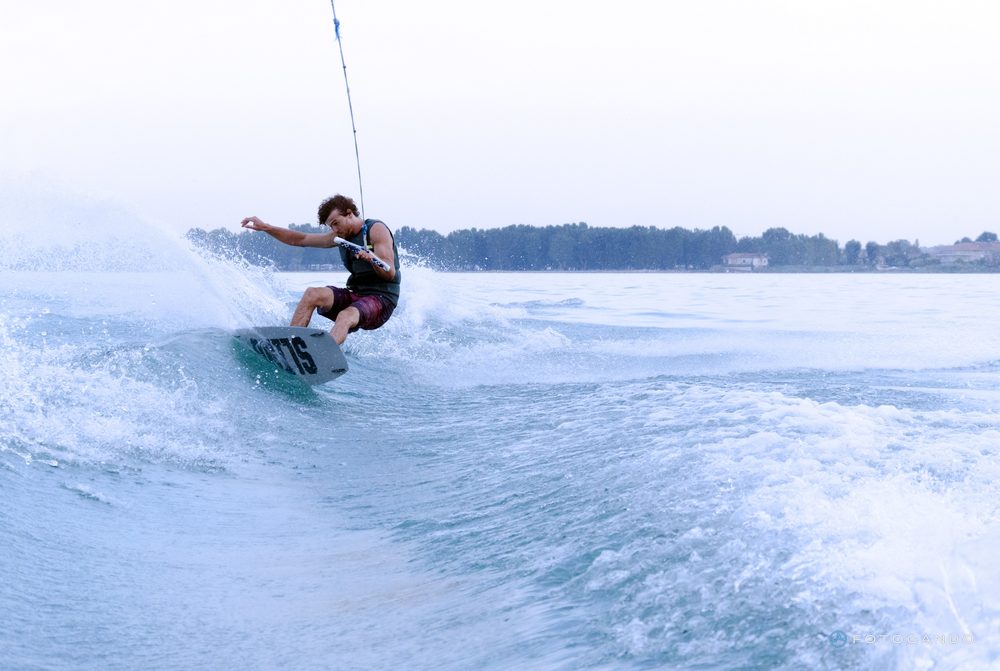 Wakeboarder carving on the wave, July 2019