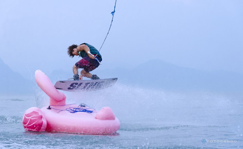Wakeboarder jumping over an inflatable flamingo, July 2019