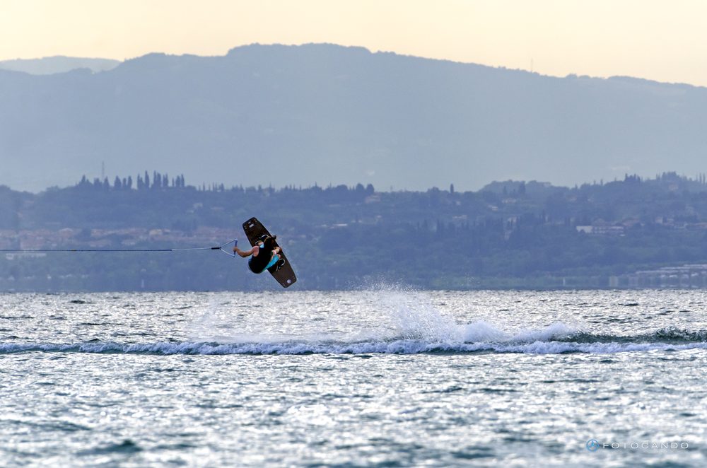 Wakeboarder in the air over the lake in the early morning, June 2019