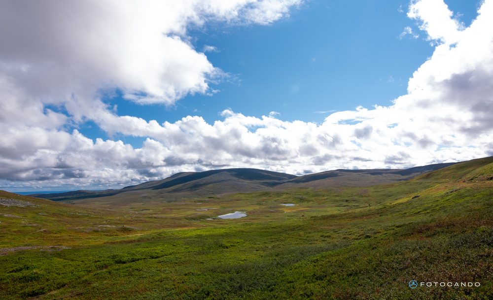 Green plateau under a cloudy sky, August 2026