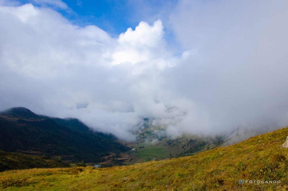 Clouds rising from the valley above the pastures