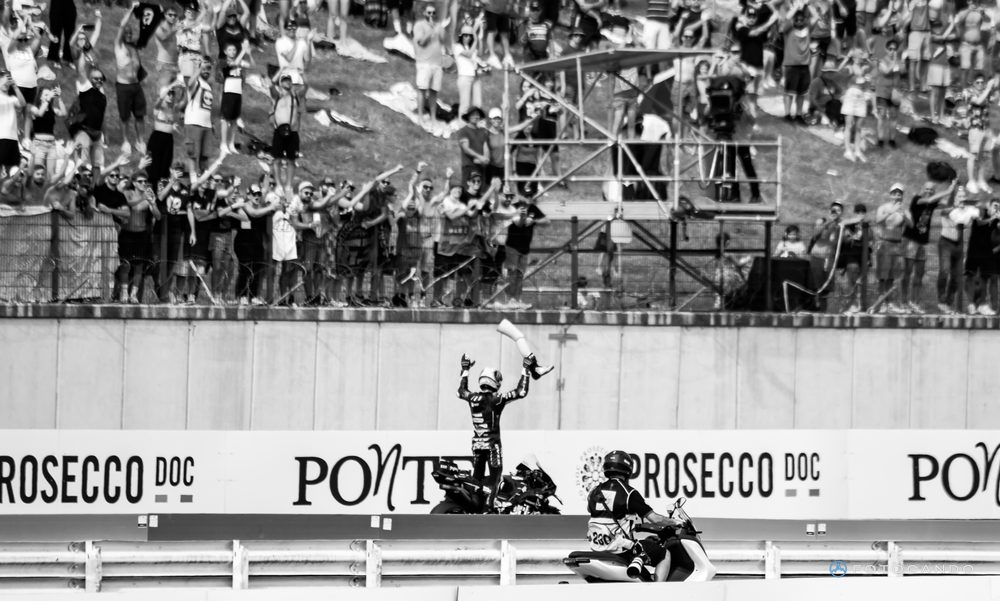 MotoGP, rider celebrating under the grandstand, in black and white, Misano 2025