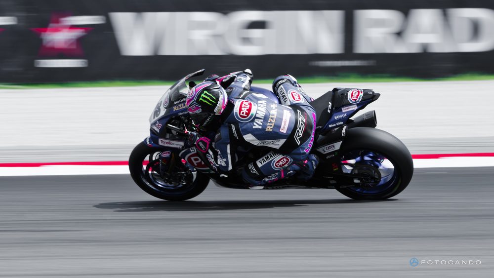 Superbike, bike leaning over in front of the billboards, June 2016