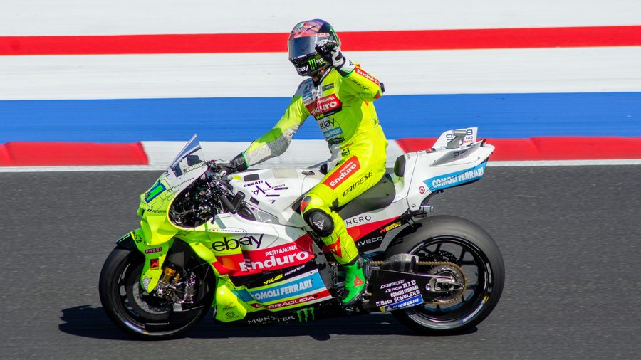 MotoGP, rider in fluorescent yellow leathers in front of the kerbs, Misano 2025